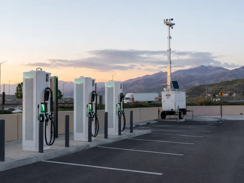 Mobile surveillance trailer with elevated thermal cameras monitoring an EV charging station in California