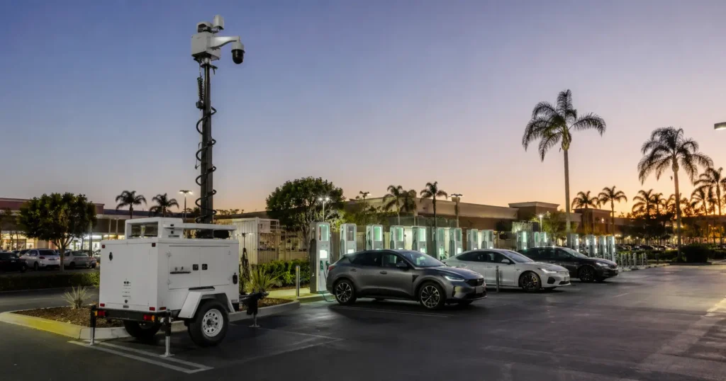 California EV charging station at twilight with mobile surveillance trailer covering the charging area