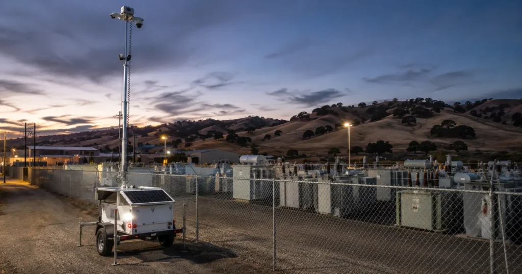 Solar mobile surveillance trailer monitoring a Northern California car dealership lot at night.