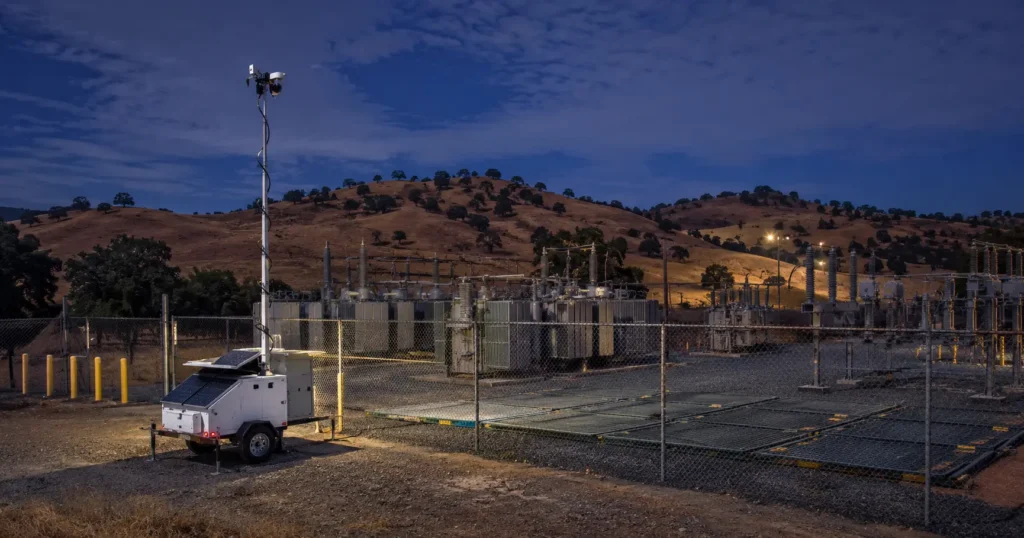 Solar mobile surveillance trailer securing a Fresno, California construction jobsite at night.