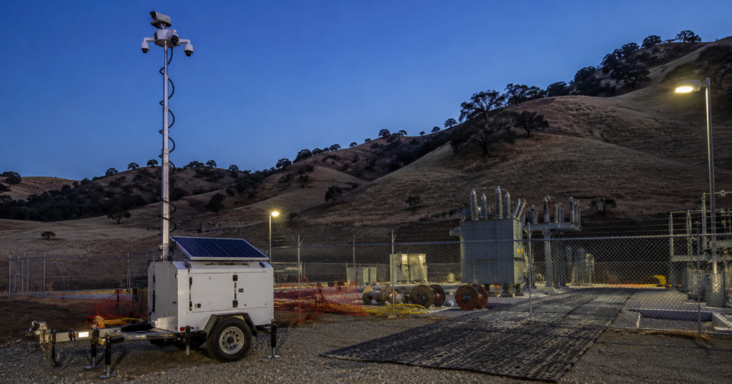 Solar mobile surveillance trailer securing a Stockton, California construction jobsite at night.